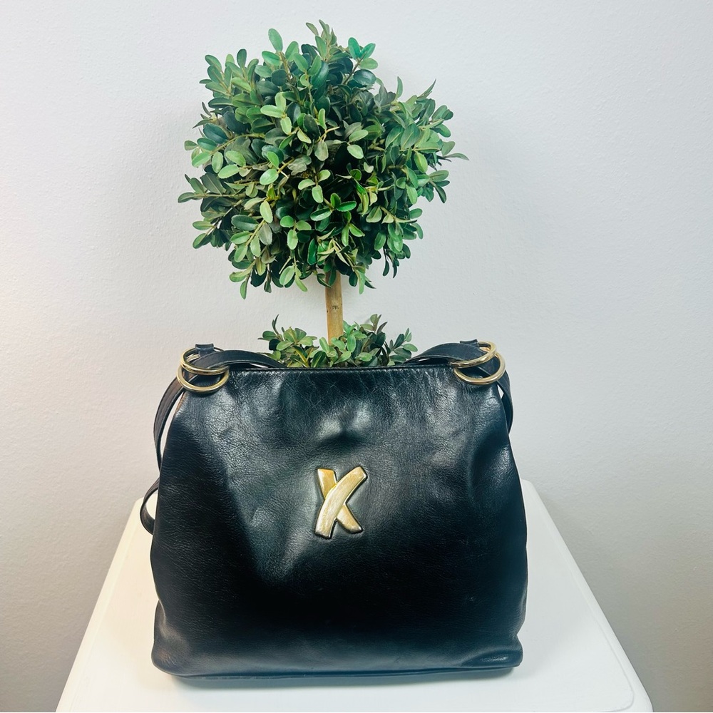 Vintage Paloma Picasso black leather shoulder bag with gold hardware.